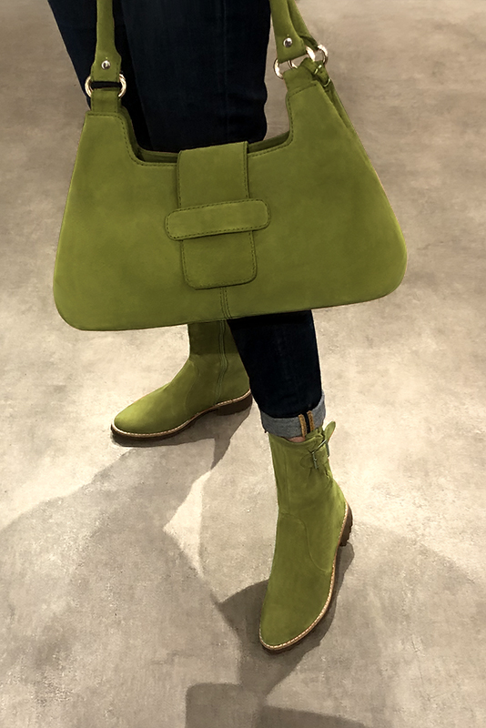 Pistachio green women's ankle boots with buckles on the sides. Round toe. Flat rubber soles. Worn view - Florence KOOIJMAN